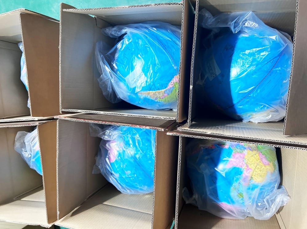 Packed globes inside cartons before sealing