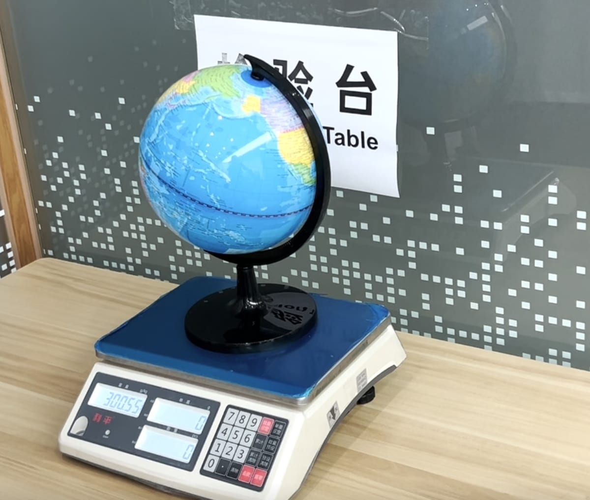 Weighing a finished globe on the inspection scale